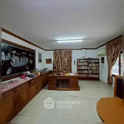 Spacious study room with elegant wooden furniture and ample natural light