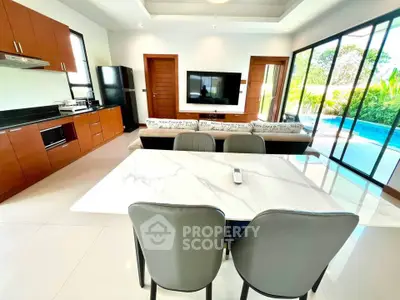 Modern open-plan living room with pool view, sleek kitchen, and elegant dining area.
