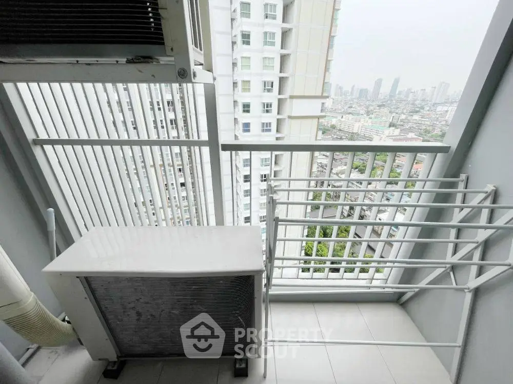 Modern balcony with city view and air conditioning unit in high-rise building.