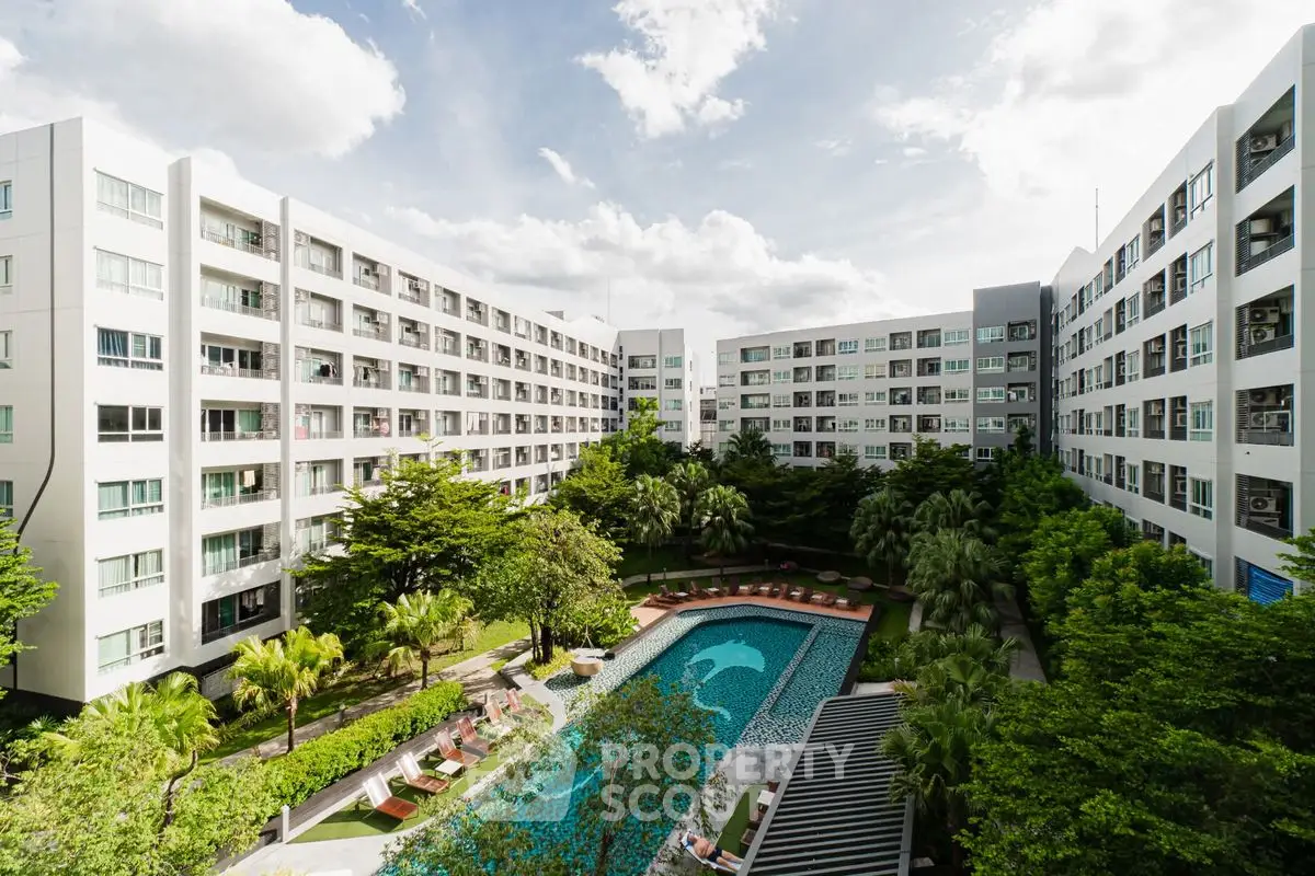 Modern apartment complex with lush garden and inviting pool view