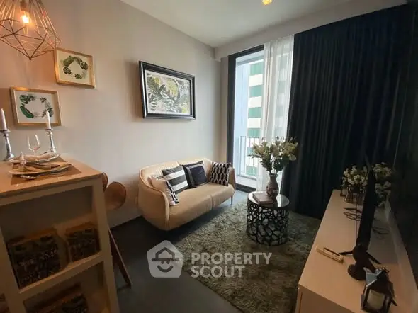 Stylish living room with cozy sofa, modern decor, and large window for natural light.