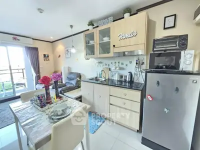 Charming open-layout kitchen and living area with modern appliances and cozy decor.