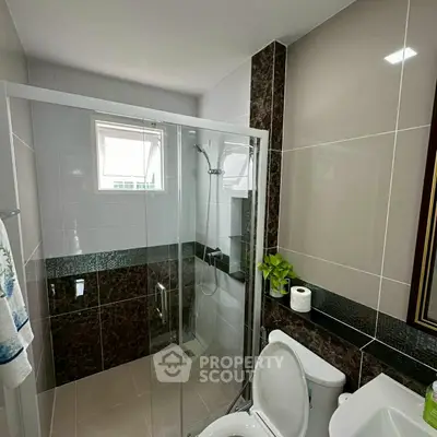 Modern bathroom with glass shower and elegant tile design