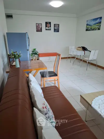 Cozy living room with modern decor and dining area, perfect for relaxation and entertaining.