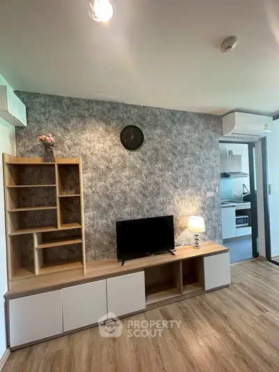 Modern living room with stylish TV unit and open kitchen layout