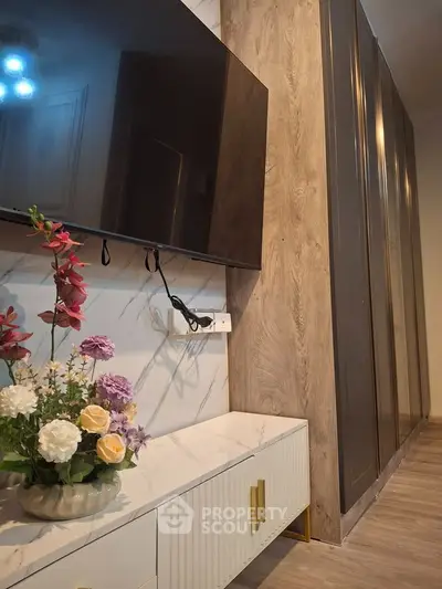 Modern living room with wall-mounted TV and elegant floral decor