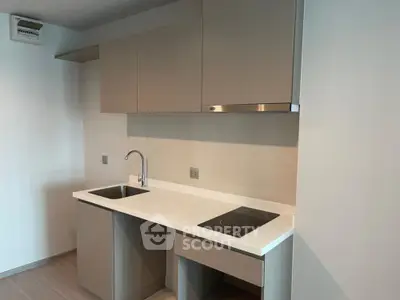 Modern minimalist kitchen with sleek cabinetry and induction cooktop