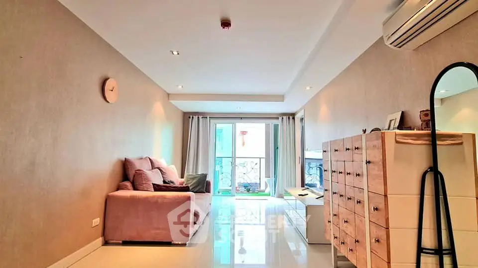 Spacious living room with modern decor and natural light in a stylish apartment.