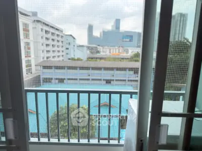Urban balcony with city skyline view, perfect for relaxation and enjoying the scenery.