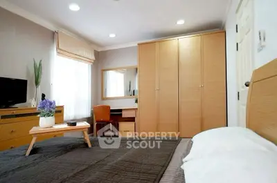 Spacious bedroom with modern furniture and natural light