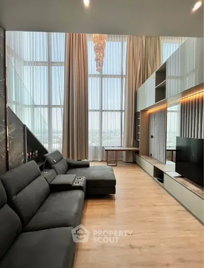 Luxurious modern living room with high ceilings and panoramic windows