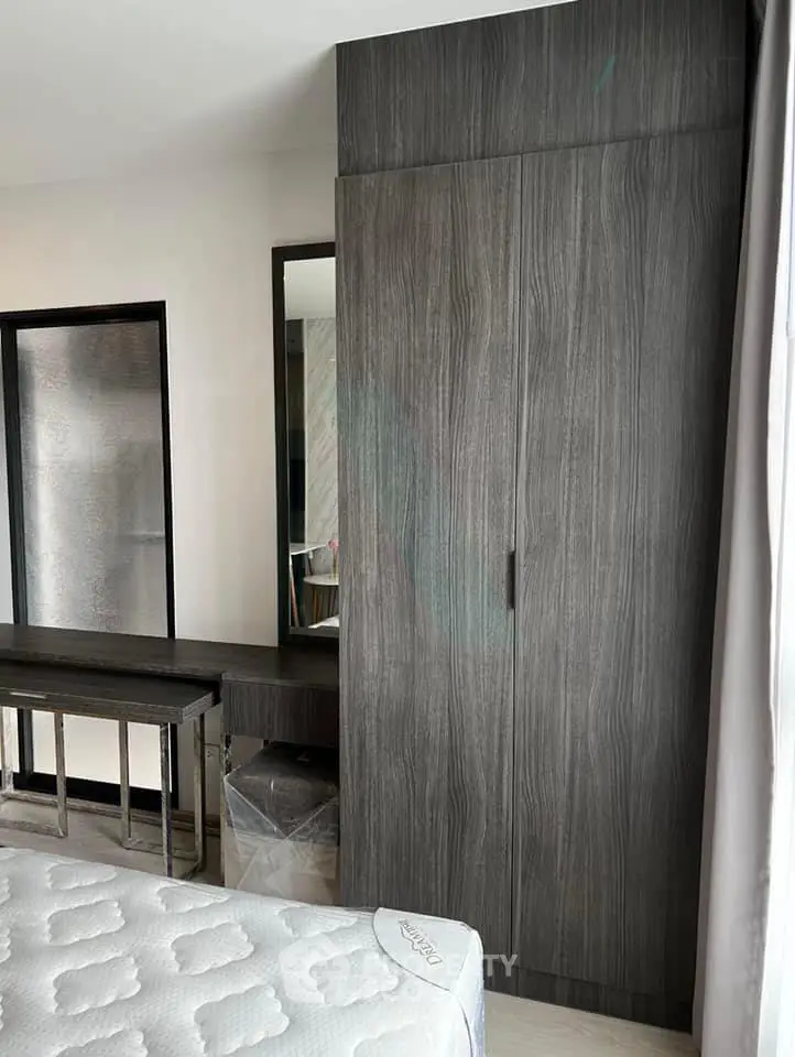 Modern bedroom with sleek wardrobe and comfortable mattress, perfect for stylish living.