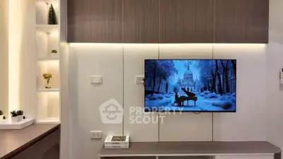 Modern living room with wall-mounted TV and elegant shelving