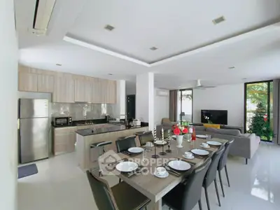 Modern open-plan kitchen and living room with sleek design and natural light