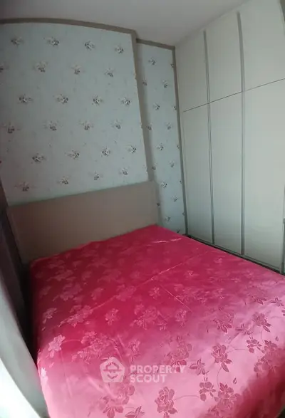 Cozy bedroom with floral wallpaper and built-in wardrobe