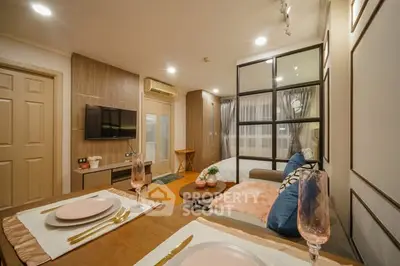 Modern living room with stylish decor and open layout, featuring a cozy seating area and elegant dining setup.