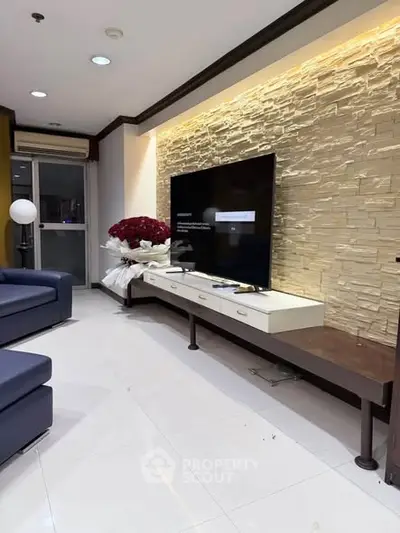 Modern living room with stylish stone accent wall and sleek furniture