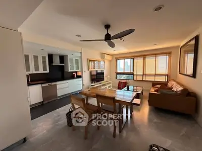 Spacious open-layout living room with modern kitchen and dining area