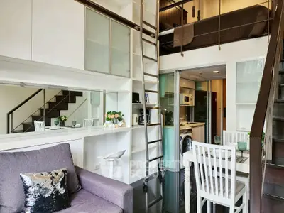 Modern loft apartment with stylish interior, featuring a cozy living area and compact kitchen.