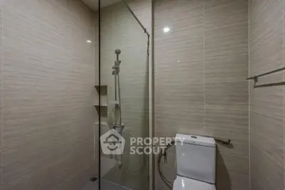 Modern bathroom with sleek shower and toilet in neutral tones