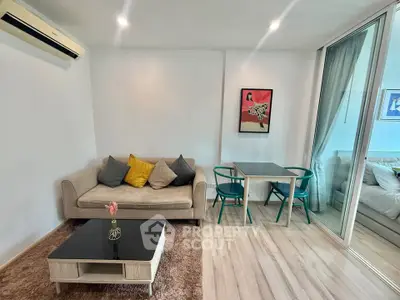 Modern living room with cozy sofa, stylish decor, and dining area in open layout apartment.