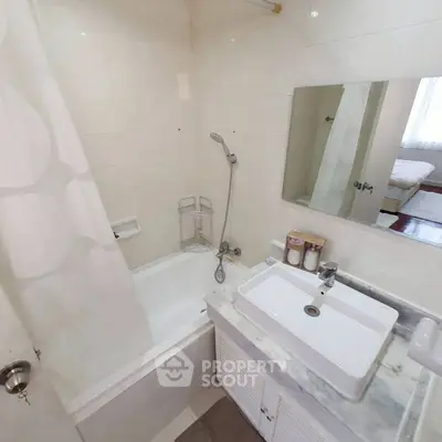 Cozy bathroom with bathtub and modern sink in a bright apartment.