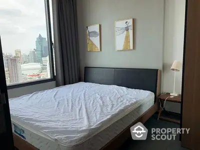 Cozy bedroom with a comfortable queen-size bed, modern furnishings, and a stunning city view through large windows, perfect for urban living.