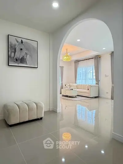 Elegant living room with archway, plush seating, and modern decor