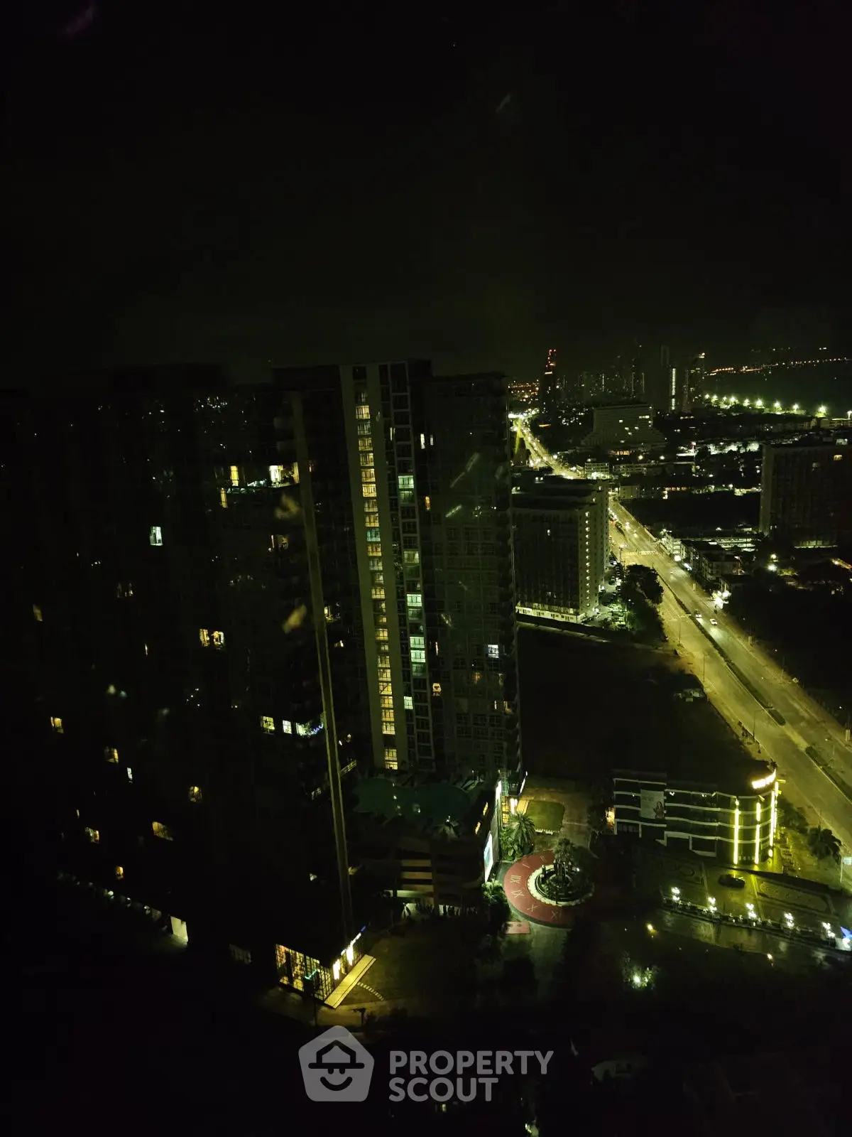 Stunning night view of cityscape with illuminated buildings and roads.
