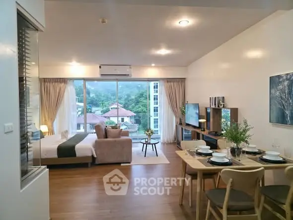 Spacious open-plan living room with dining area and scenic view, perfect for modern living.