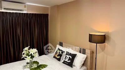 Cozy bedroom with elegant decor and soft lighting, featuring a comfortable bed and stylish pillows.