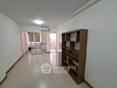 Spacious apartment interior with modern shelving and view into bathroom