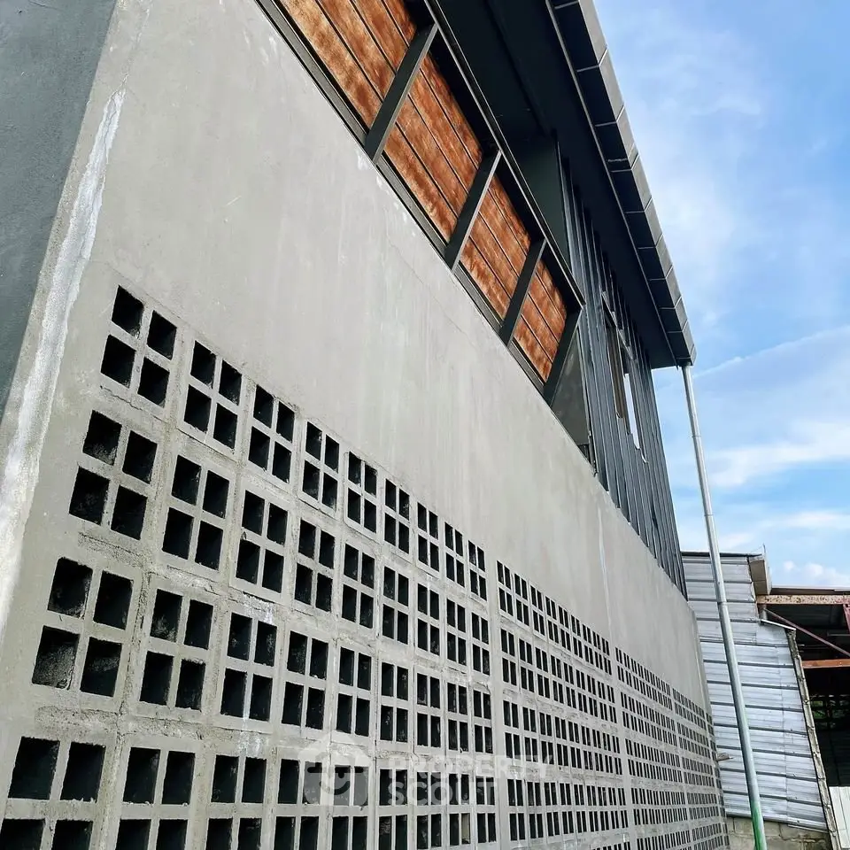 Modern architectural building with unique concrete block design and wooden accents.