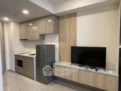 Modern kitchen with sleek cabinetry and integrated appliances in a stylish apartment.