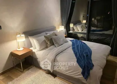 Cozy modern bedroom with stylish decor and large window view
