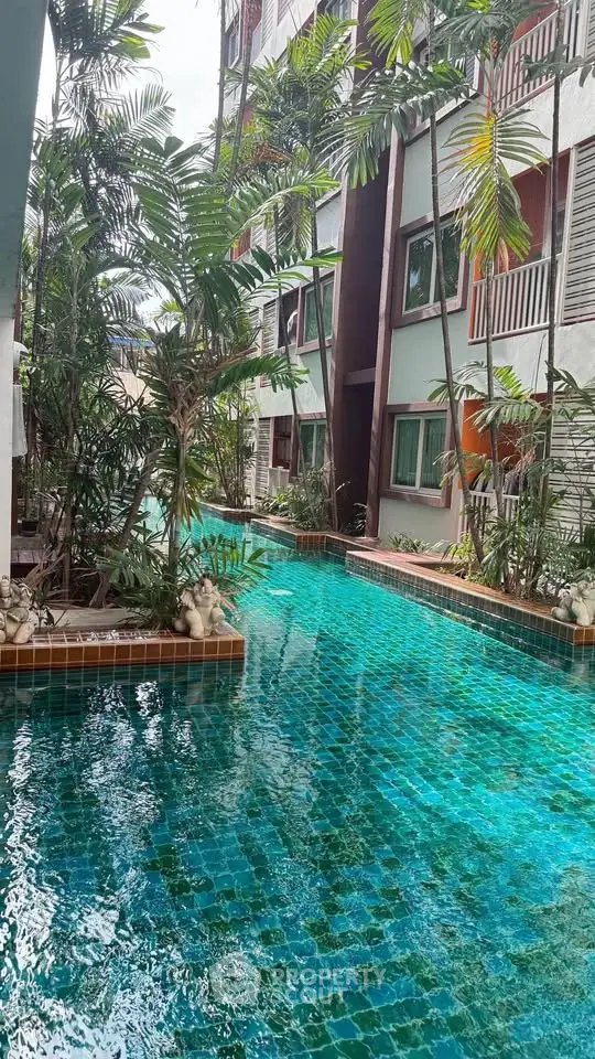 Stunning poolside view with lush greenery at a modern apartment complex.