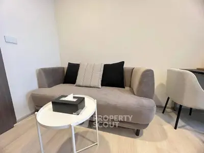 Cozy living room with modern sofa and stylish decor in a contemporary apartment.