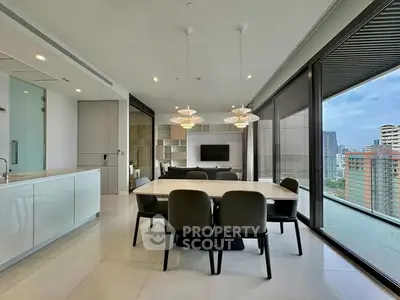 Luxurious open-plan living and dining area with stunning city view and modern furnishings.