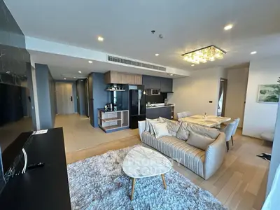 Modern open-plan living room with stylish kitchen and cozy seating area.