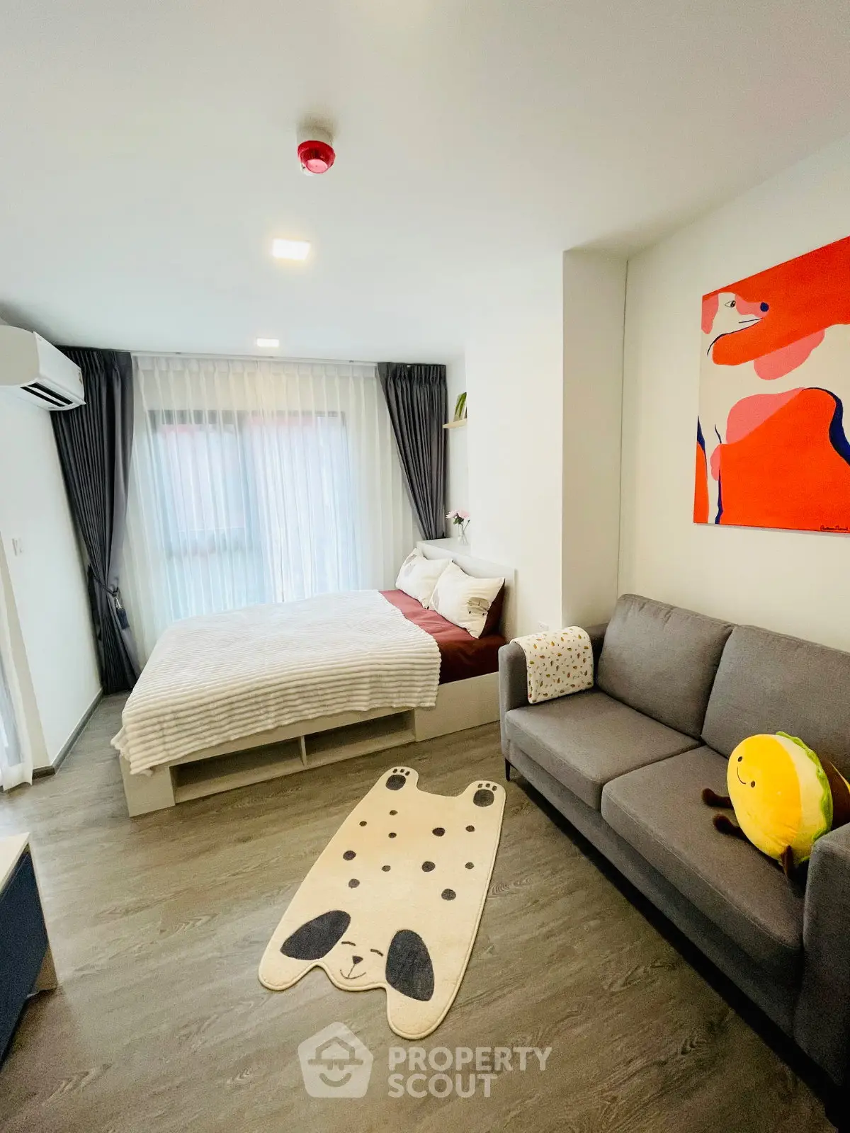 Modern studio apartment with cozy bed and stylish decor