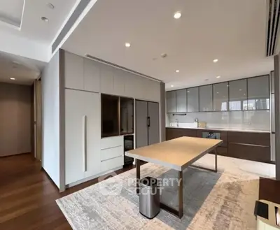 Spacious modern kitchen with sleek cabinetry and large dining table