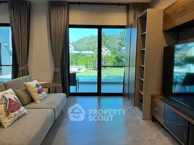 Modern living room with pool view and stylish decor