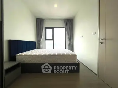 Modern minimalist bedroom with large window and stylish bed frame