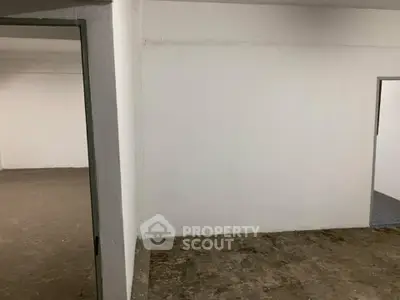 Spacious unfinished interior space with concrete floors and white walls, ideal for customization.