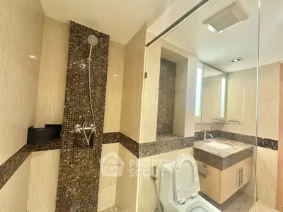 Modern bathroom with elegant tile design and glass shower enclosure