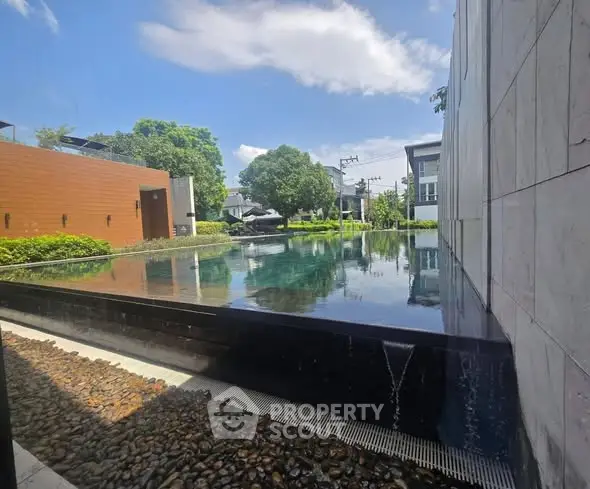 Luxurious modern pool with serene surroundings and elegant architecture.