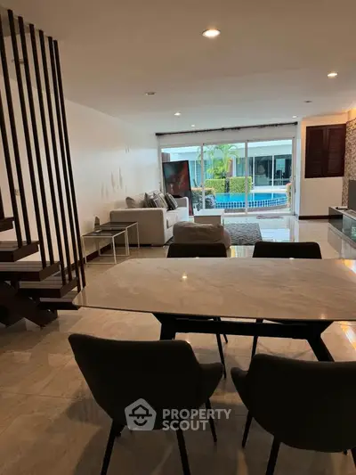 Spacious living room with pool view and modern interior design