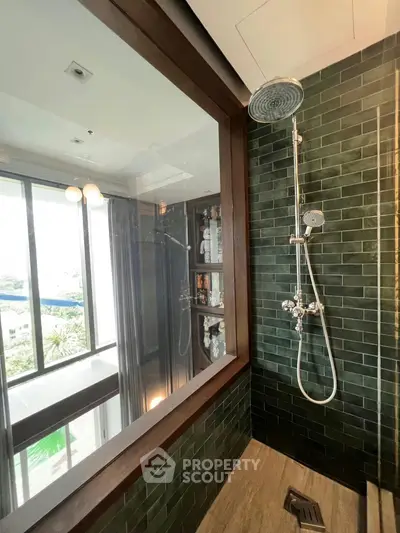 Luxurious bathroom with modern shower and large window offering stunning views.