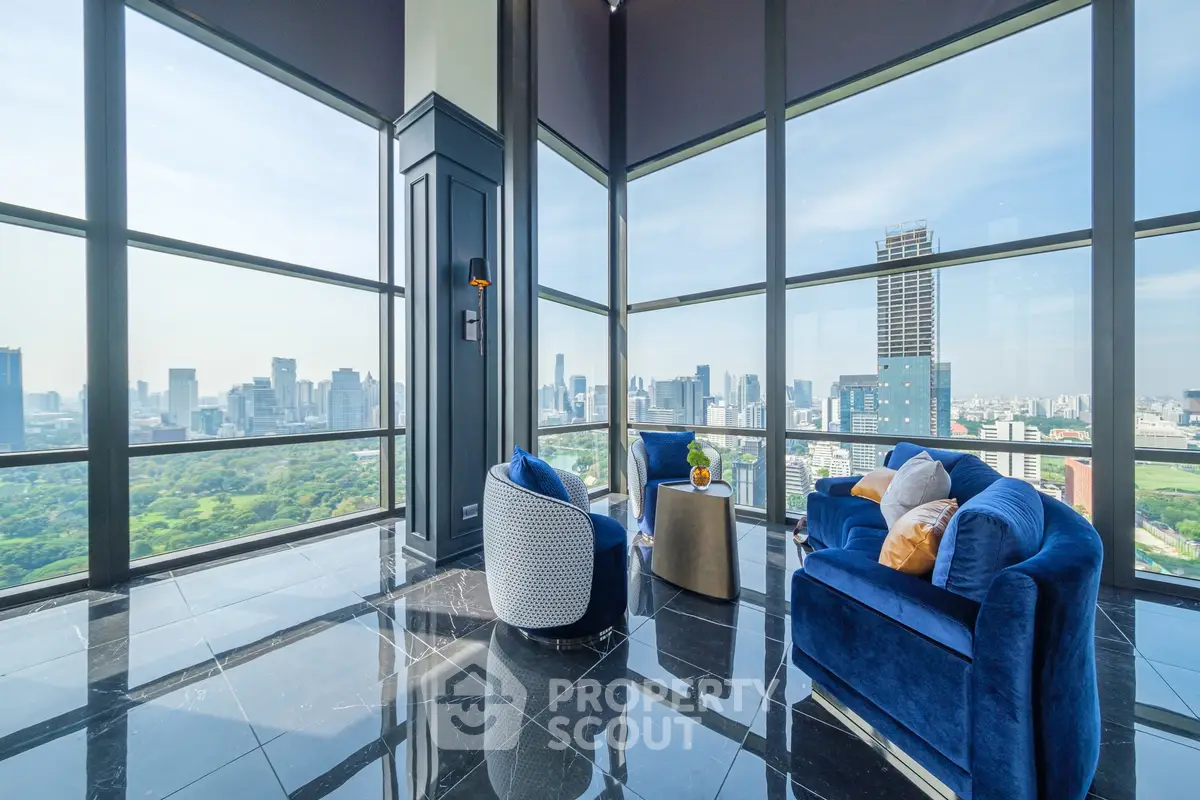 Luxurious high-rise living room with panoramic city views and elegant blue furnishings.