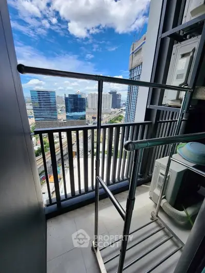 Modern high-rise balcony with stunning city view and sleek railing design.